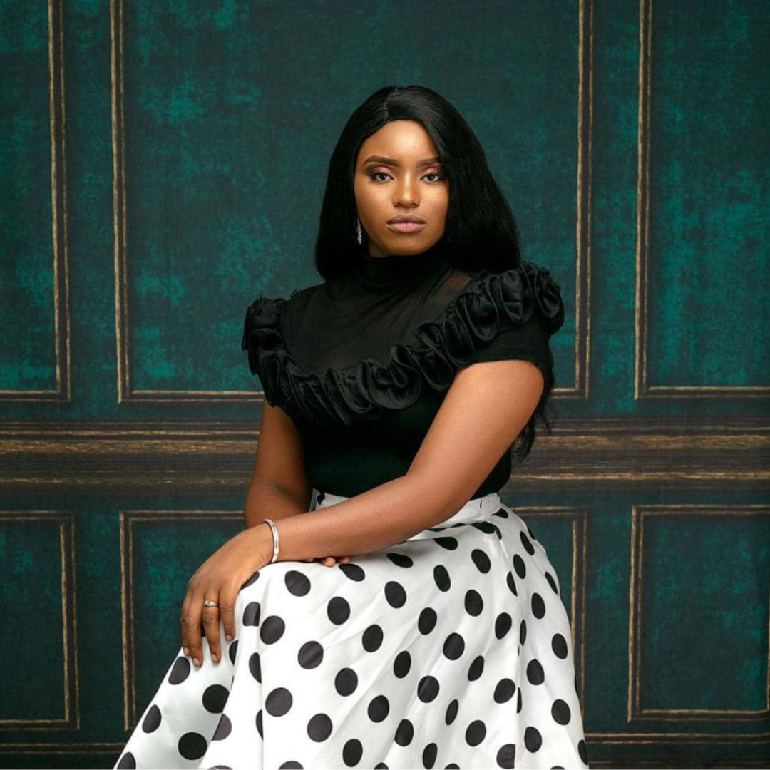 Jennifer O. on black top and white skirt with big black dots